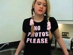 19yo A Young, Blonde Girl Is Standing In The Kitchen Corner. The Cameraman Asks Her To Lift Her T-shirt So He Can Film Her Large Breasts. The Girl Then Rem